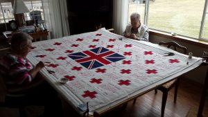 Members of the Twilight Quilters' Guild working on the WWI Memorial Red Cross Quilt